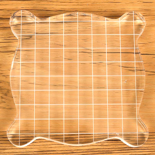 a square-shaped transparent acrylic stamp block
