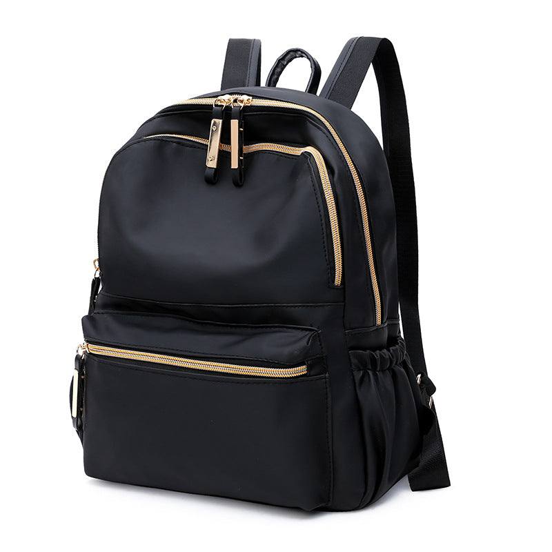 a black backpack with gold alloy zipper