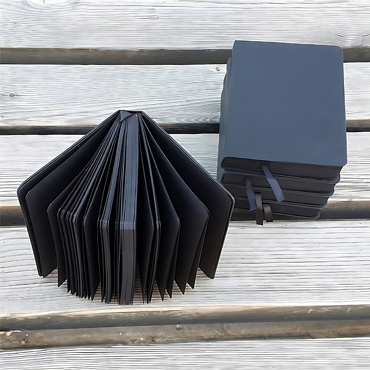 black notebooks on a wooden surface