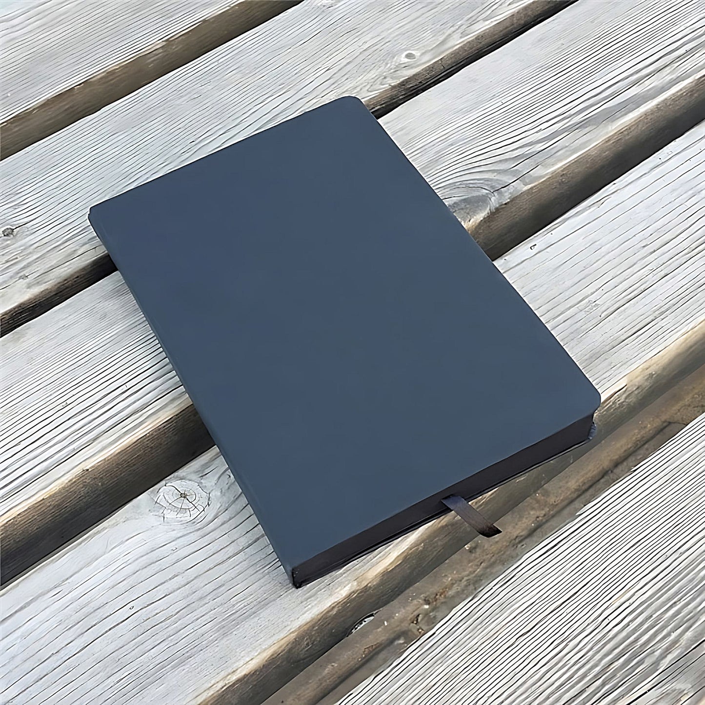 a black notebook on a wooden surface