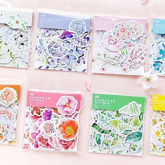 eight different set of bright flower stickers on a pink background