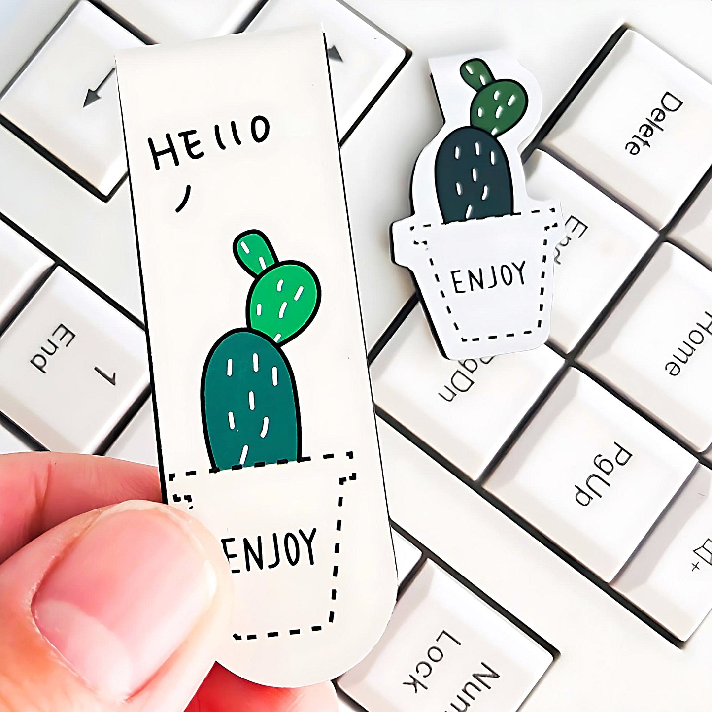 a set of Cactus magnetic bookmark on top of a keyboard