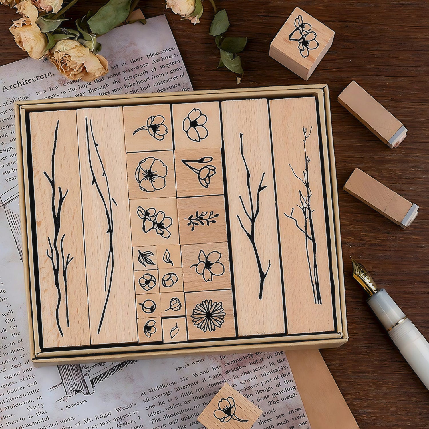an open box of a floral wood stamp set