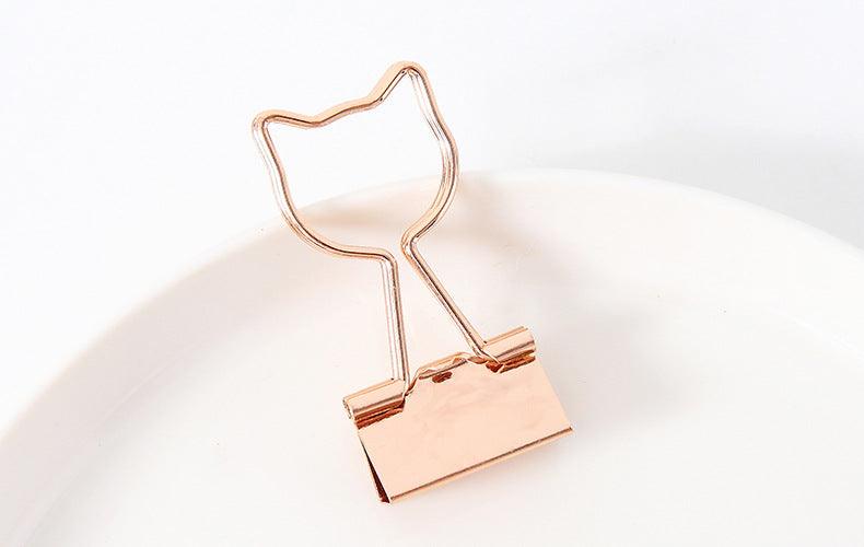 a gold binder clip in a cat shape