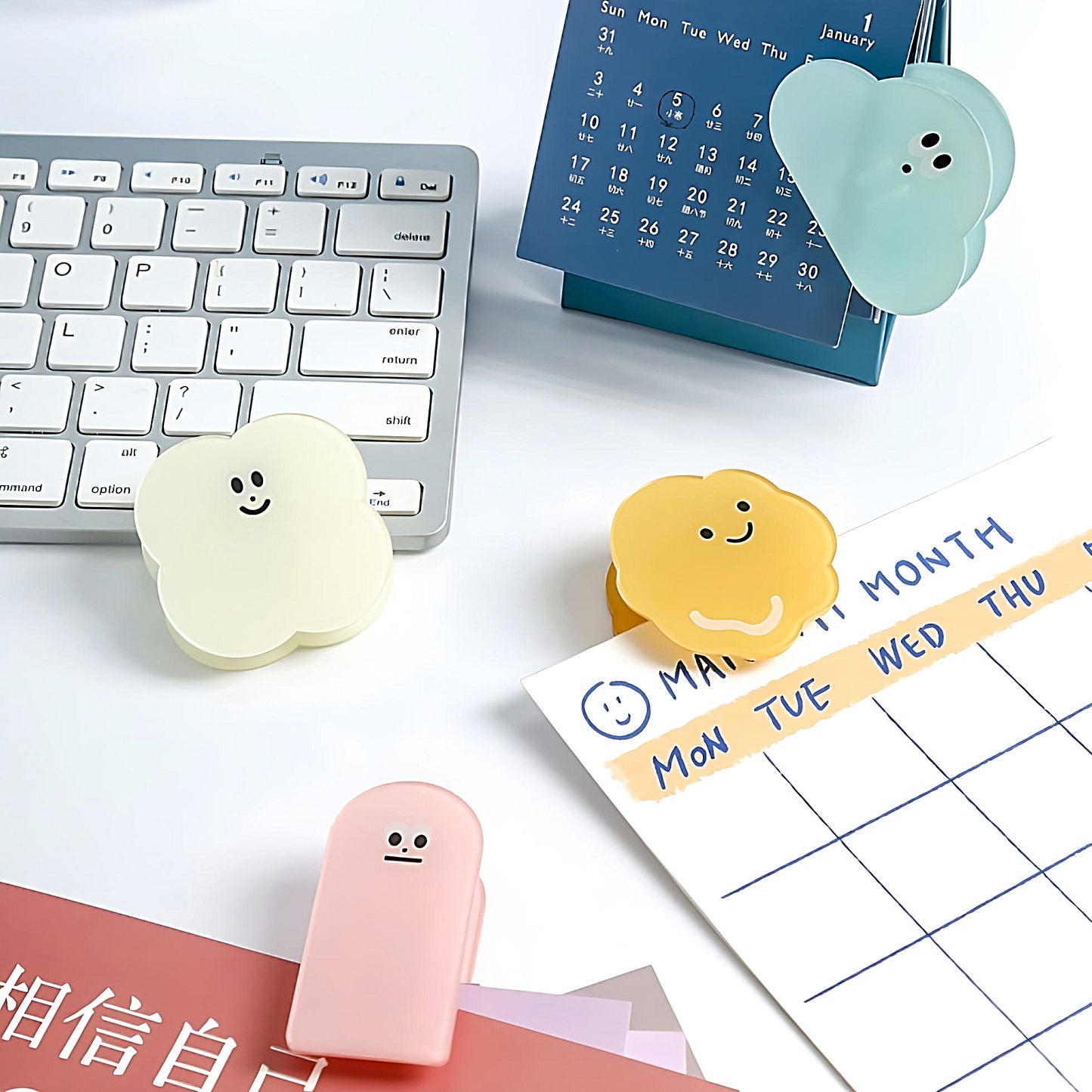 four different styles of Kawaii acrylic binder clip on a white desk