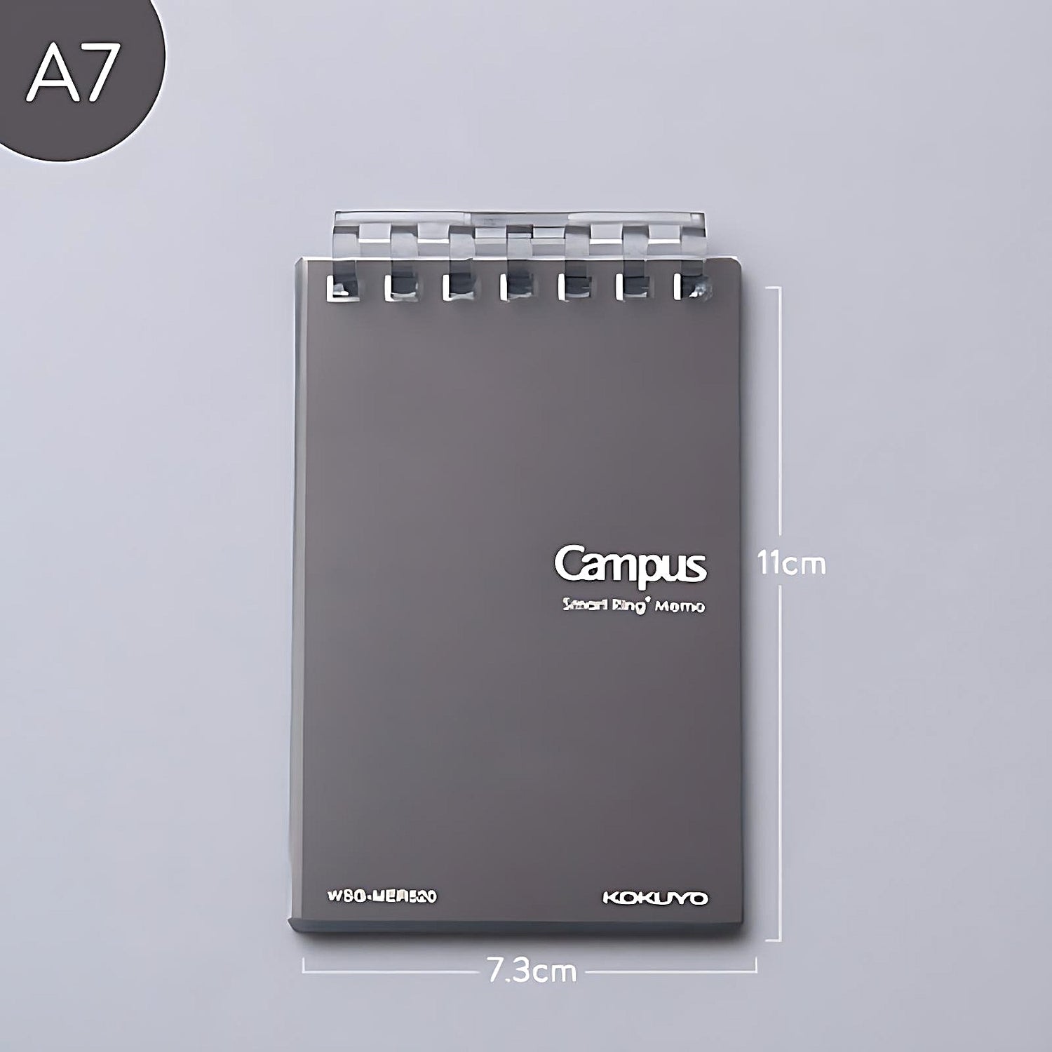 a black Kokuyo Smart Ring memo pad on a grey background