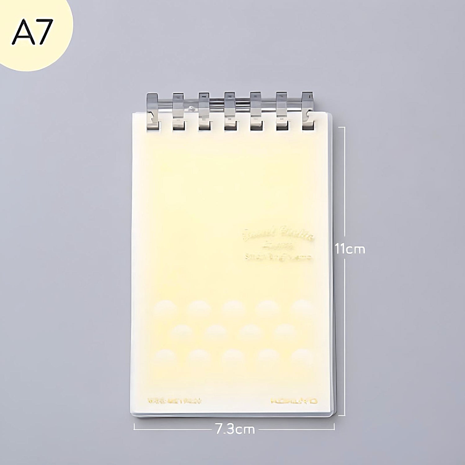 a yellow Kokuyo Smart Ring memo pad on a grey background
