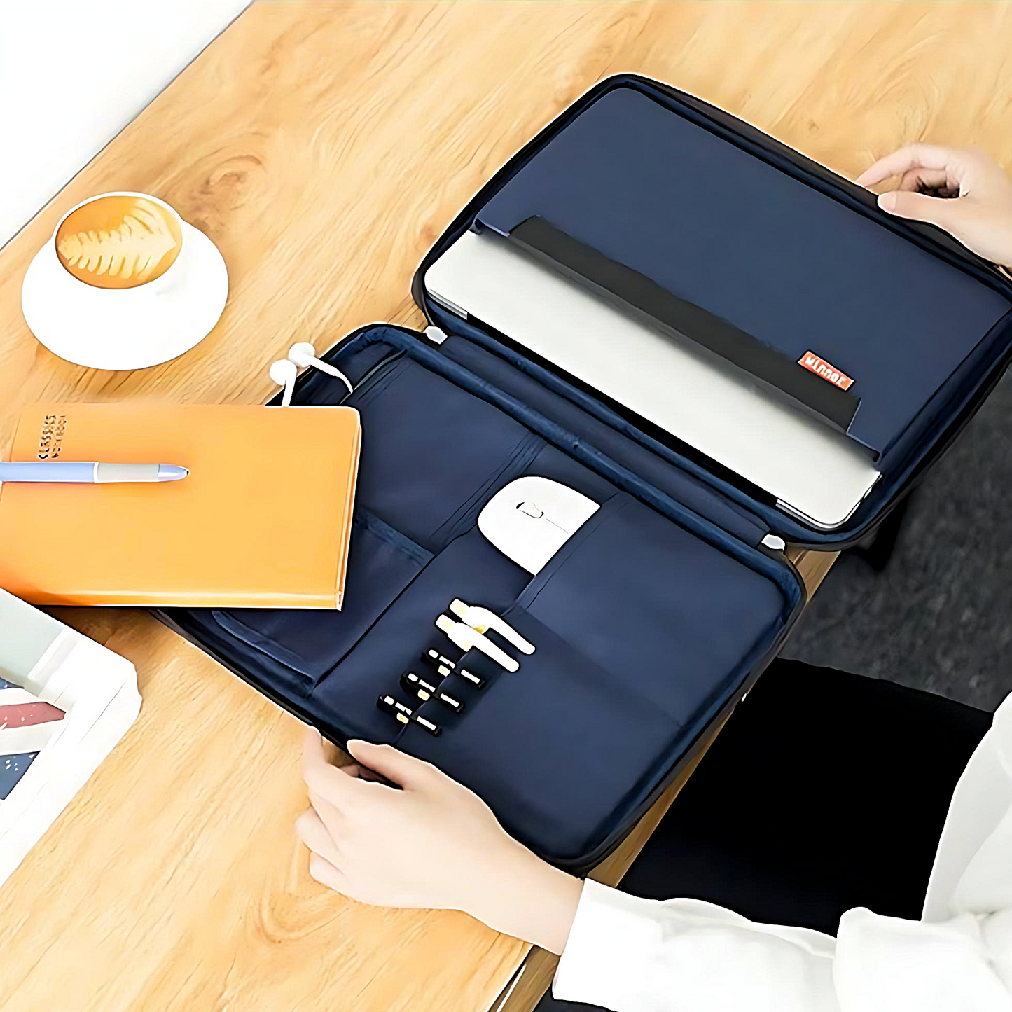 a woman with a dark blue laptop briefcase open on a wooden table