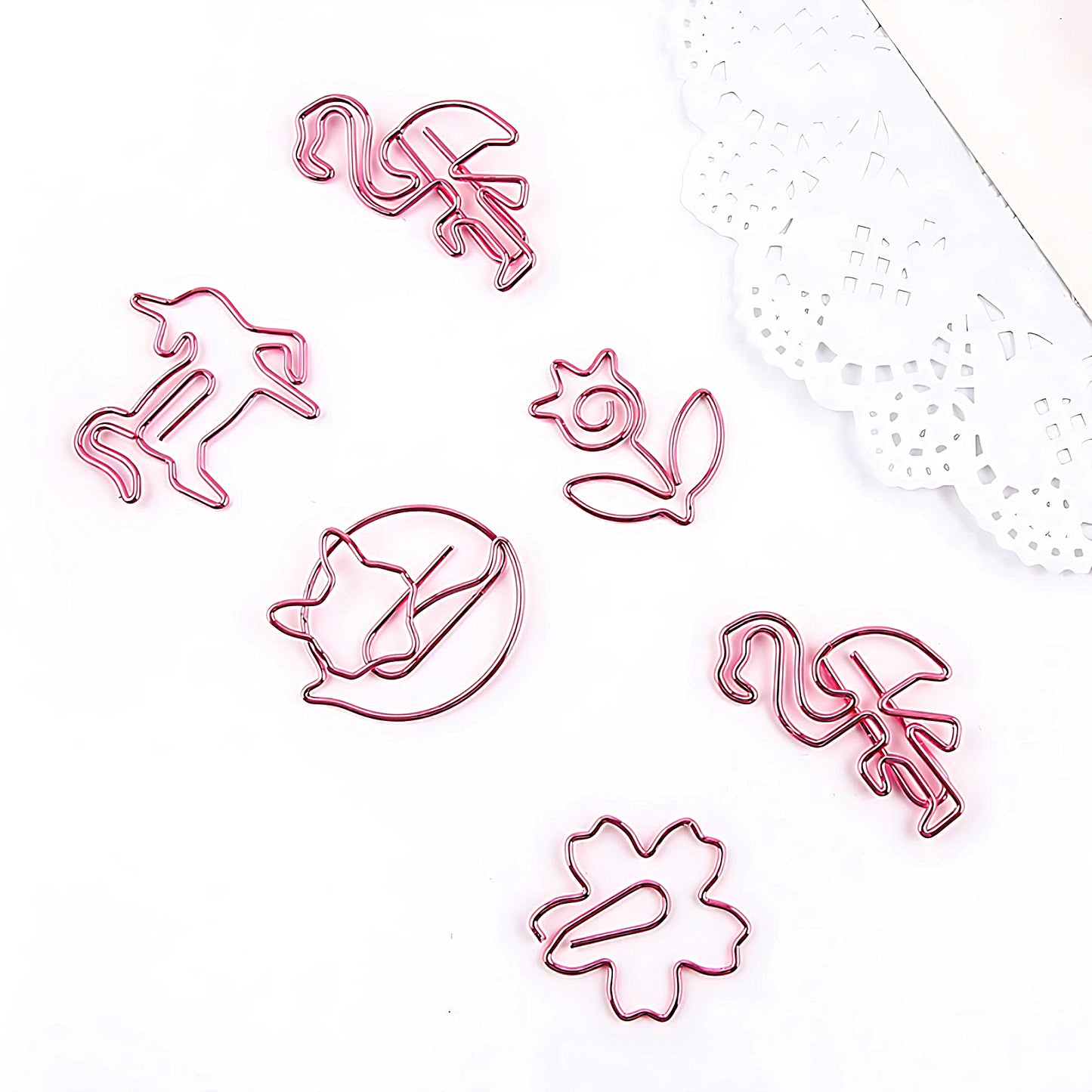 6 pink paper clips in the shape of various animals