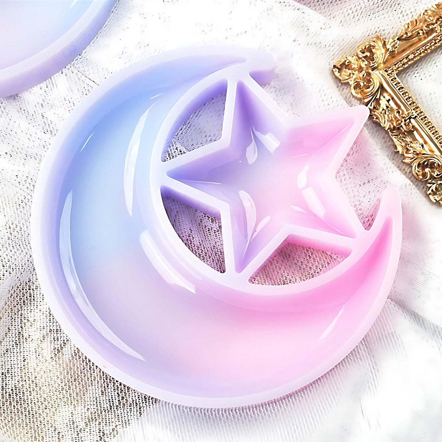 a moon crescent and star silicone mold on a white fabric