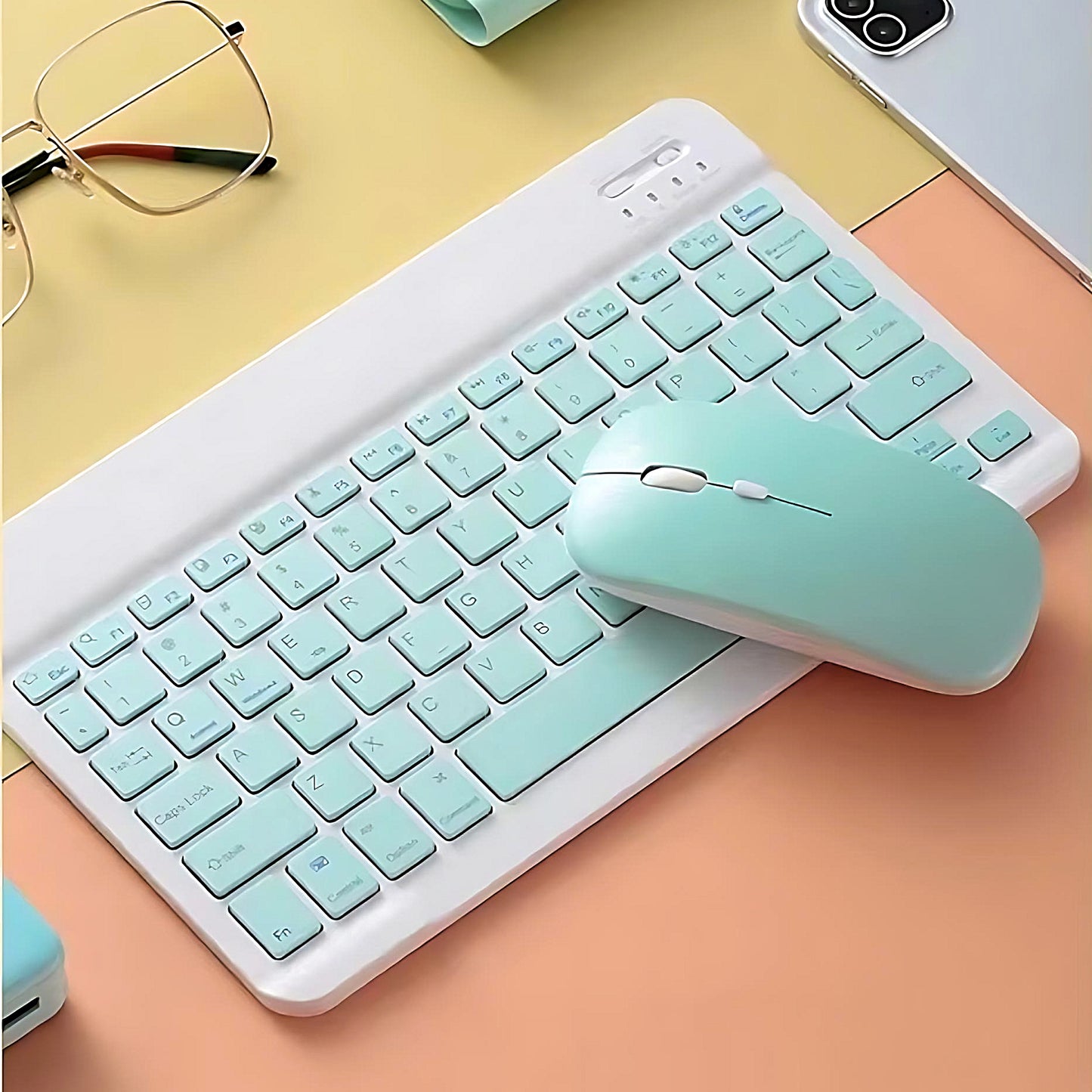 a pastel wireless keyboard and mouse set on a yellow and orange background