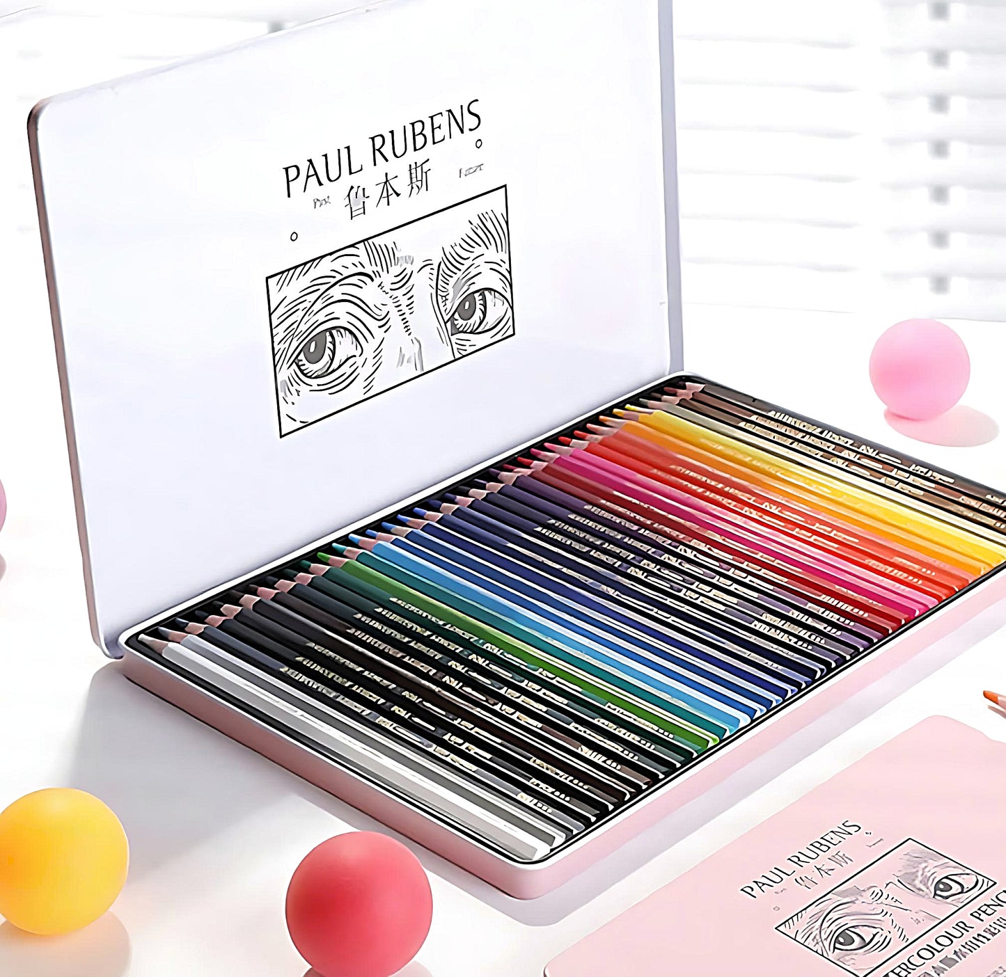 a set of Paul Rubens watercolor pencils in a pink tin box