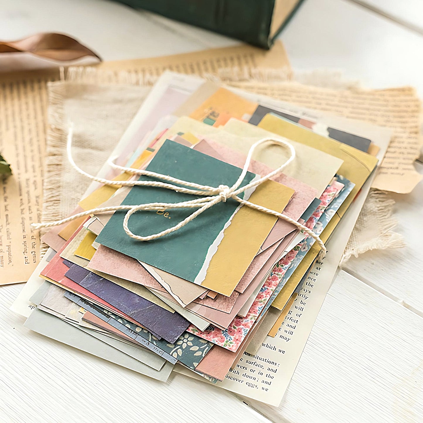 a stack of scrapbook paper tied with string
