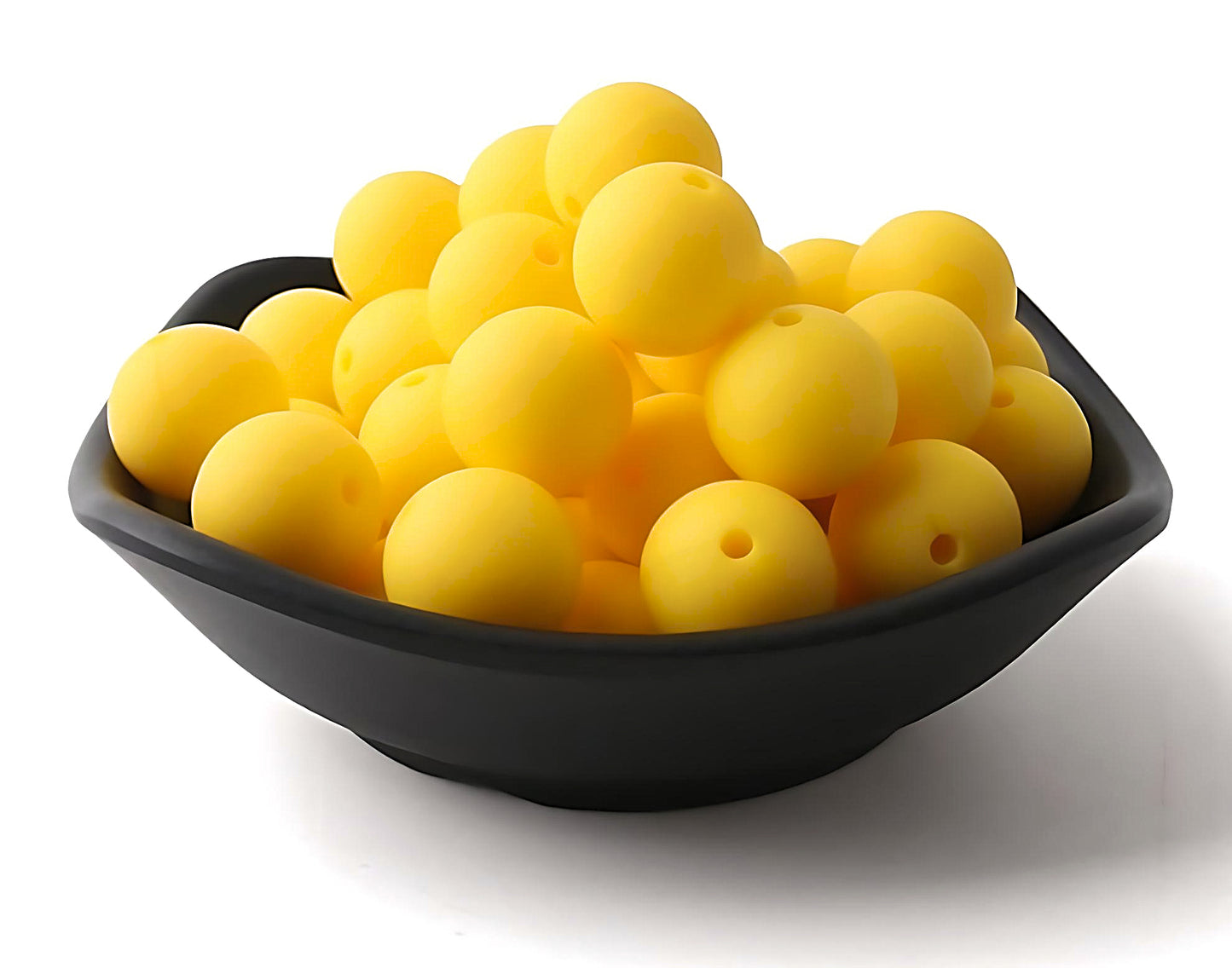 yellow silicone beads in a black bowl