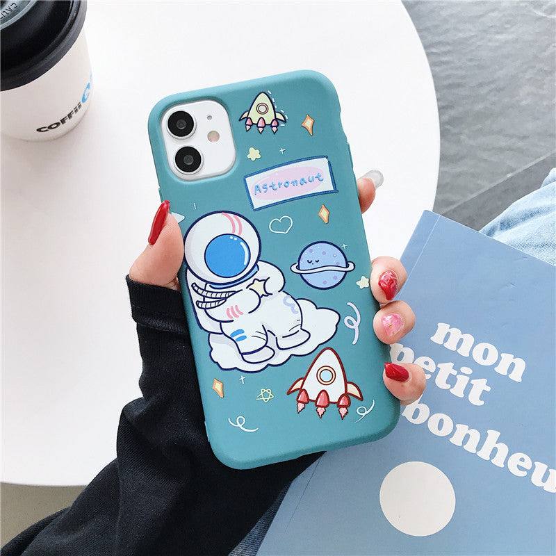 a woman holding an iPhone case with a Kawaii astronaut design on it