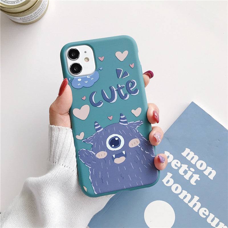 a woman holding an iPhone case with a Kawaii cute monster design on it