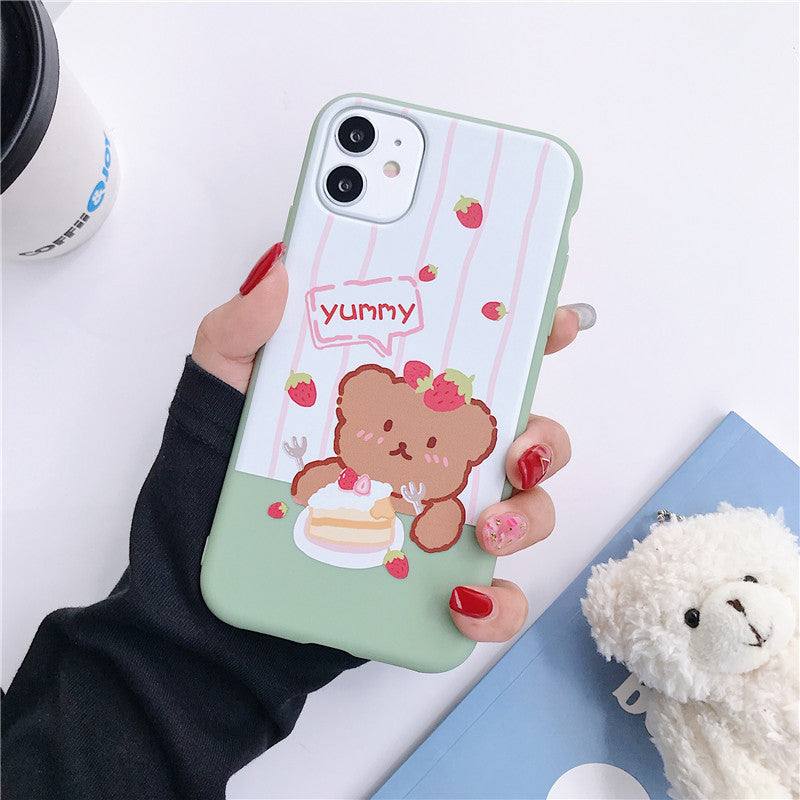 a woman holding an iPhone case with a Kawaii bear design on it